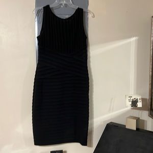 Calvin Klein sleeveless black dress with crisscross details at the waist